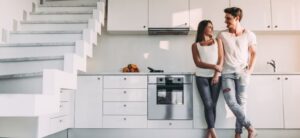 picture of two people stood in their kitchen looking happy