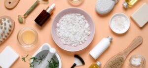 selection of bottles and creams on a salmon background
