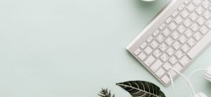 silver keyboard on a mint coloured background