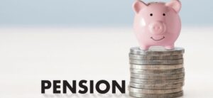 the world pension next to a stack of coins with a piggybank on top