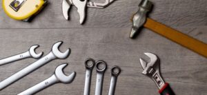 selection of tools on a wooden backdrop