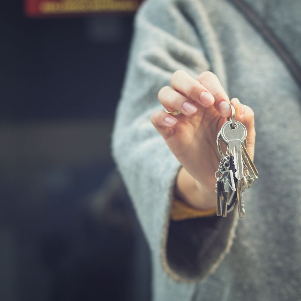 women holding a set of keys in her hand