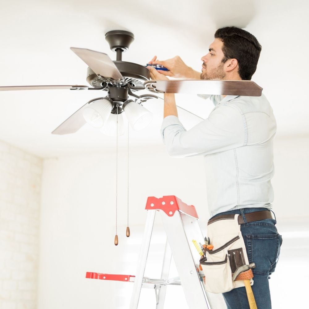 person working on a ceiling fan