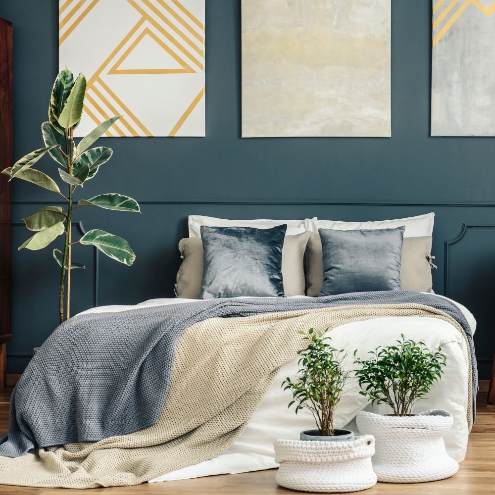 bedroom featuring wall art and lots of plants
