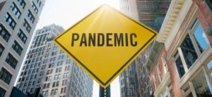 yellow sign saying pandemic on a street