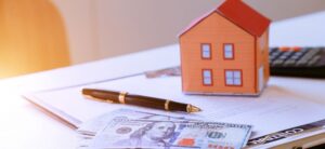 money pen calculator and small model house