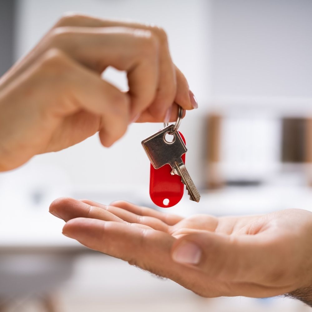 person handing keys over to another person