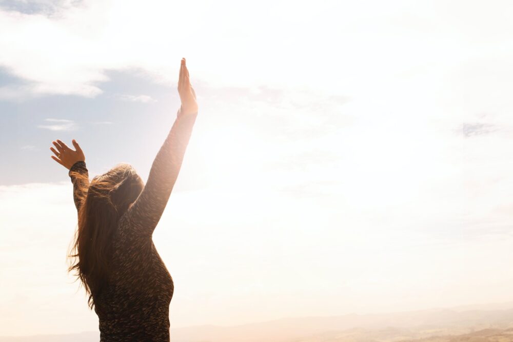 women with her arms in the air