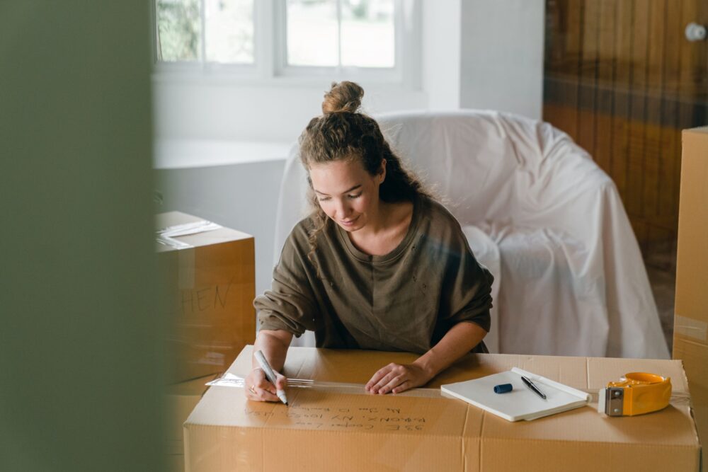 person labelling a packing box