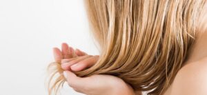 woman holding her hair gently in her hands
