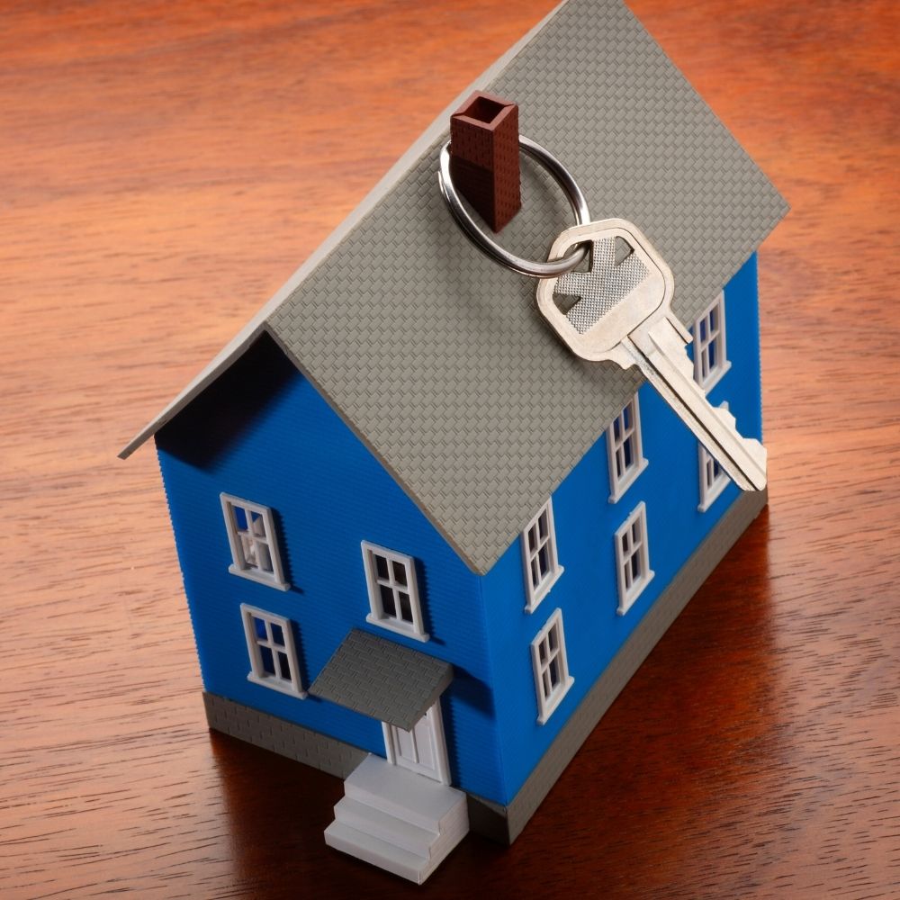 blue model house with a key linked to the roof