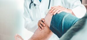 doctor looking at a persons knee