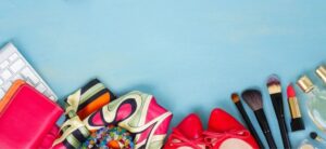fashion and makeup items against a blue background