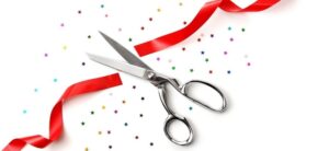 red ribbon cut with scissors and star confetti