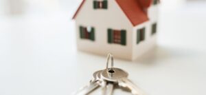 small model house with keys infront