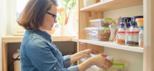 woman placing item on storage shelves