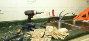 drill and tools sat by a sink