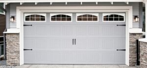 large set of garage doors grey in colour with windows to the top