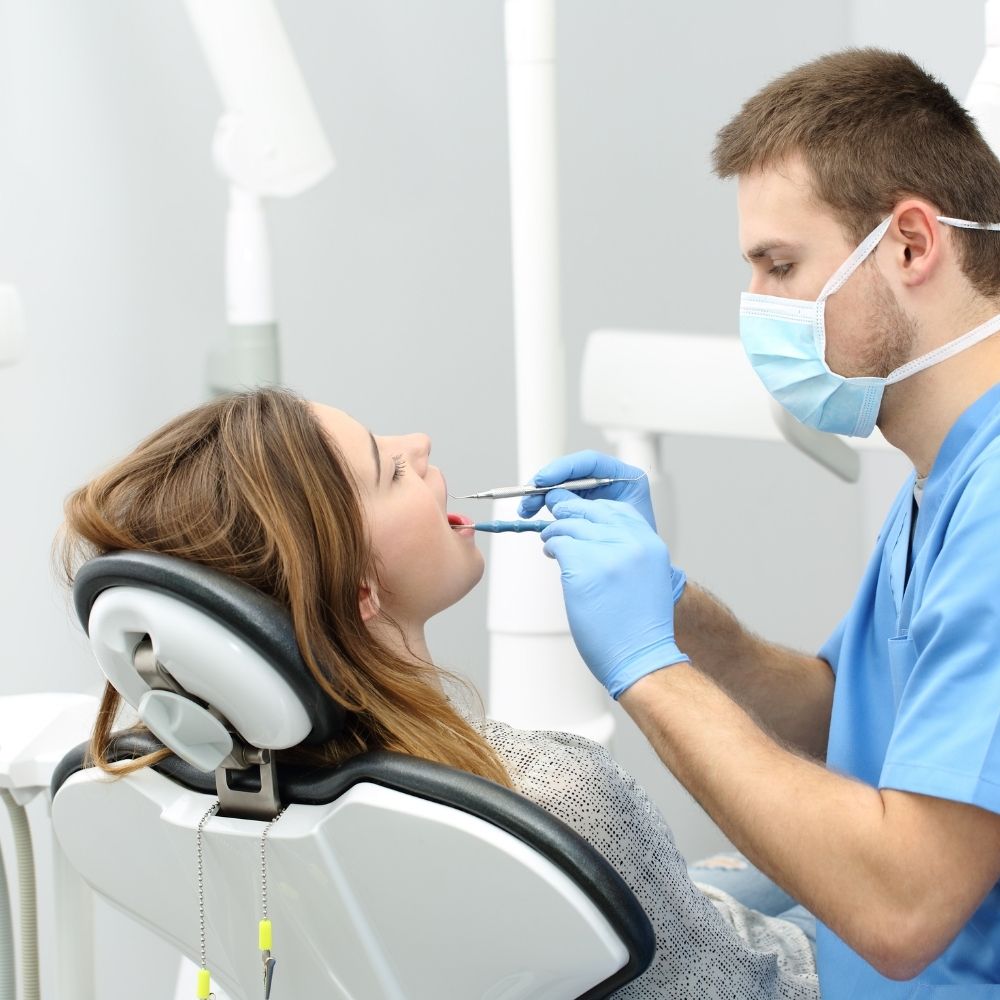person having their teeth looked at by a dentist