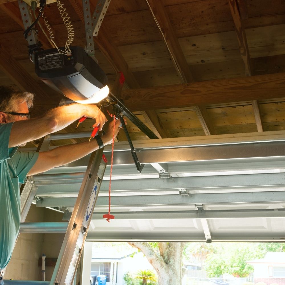person working on a garage door