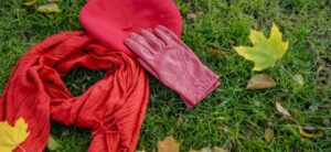 red hat gloves and scarf on grass