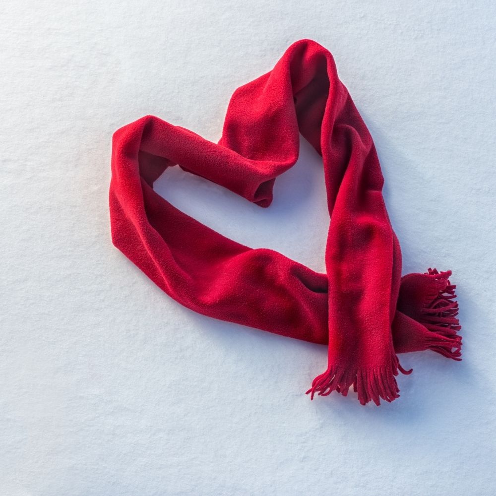 red scarf laid out in the shape of a heart