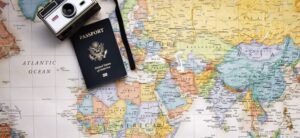 world map passport and camera