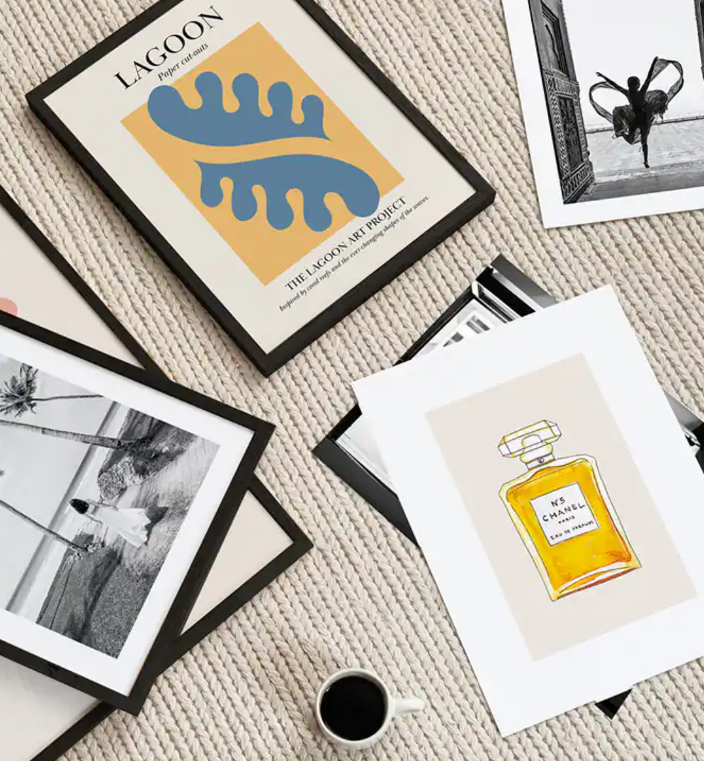 desenio image of prints both framed and unframed with a coffee nearby