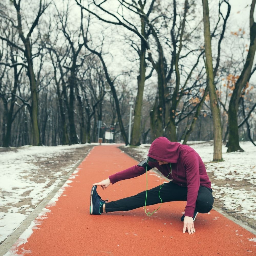 person doing stretches on a cold day