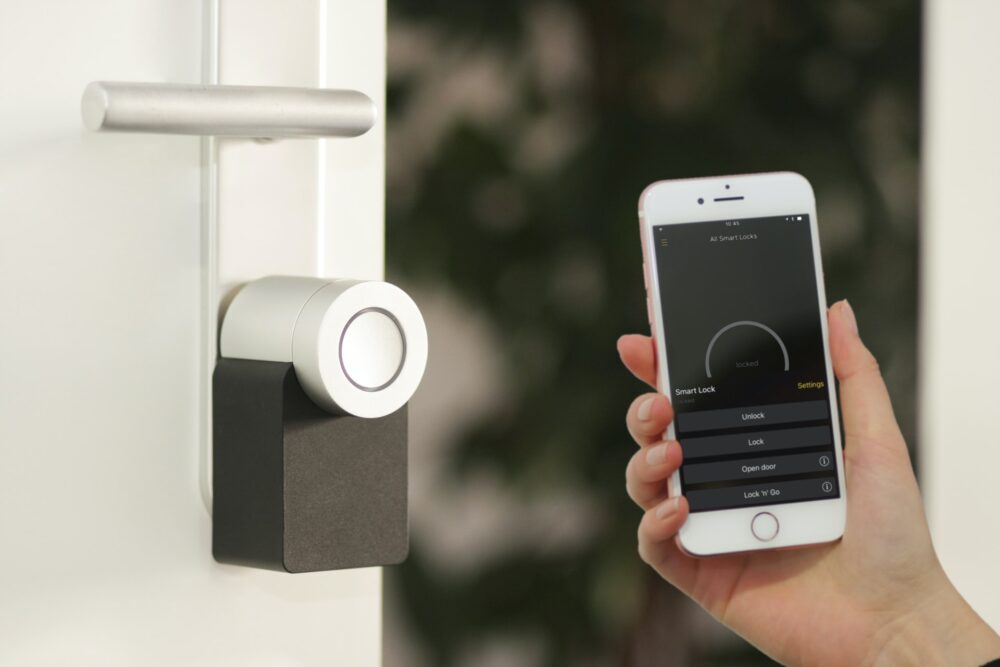 mobile phone held nearby a door locking mechanism