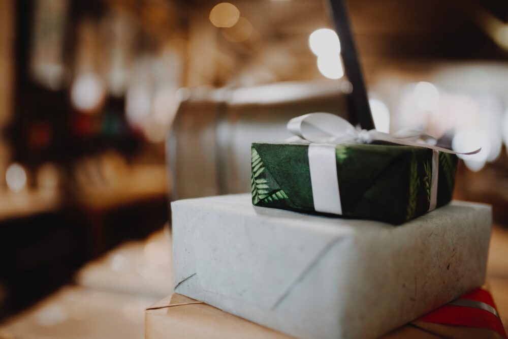 green parcel tied with a ribbon waiting to be opened