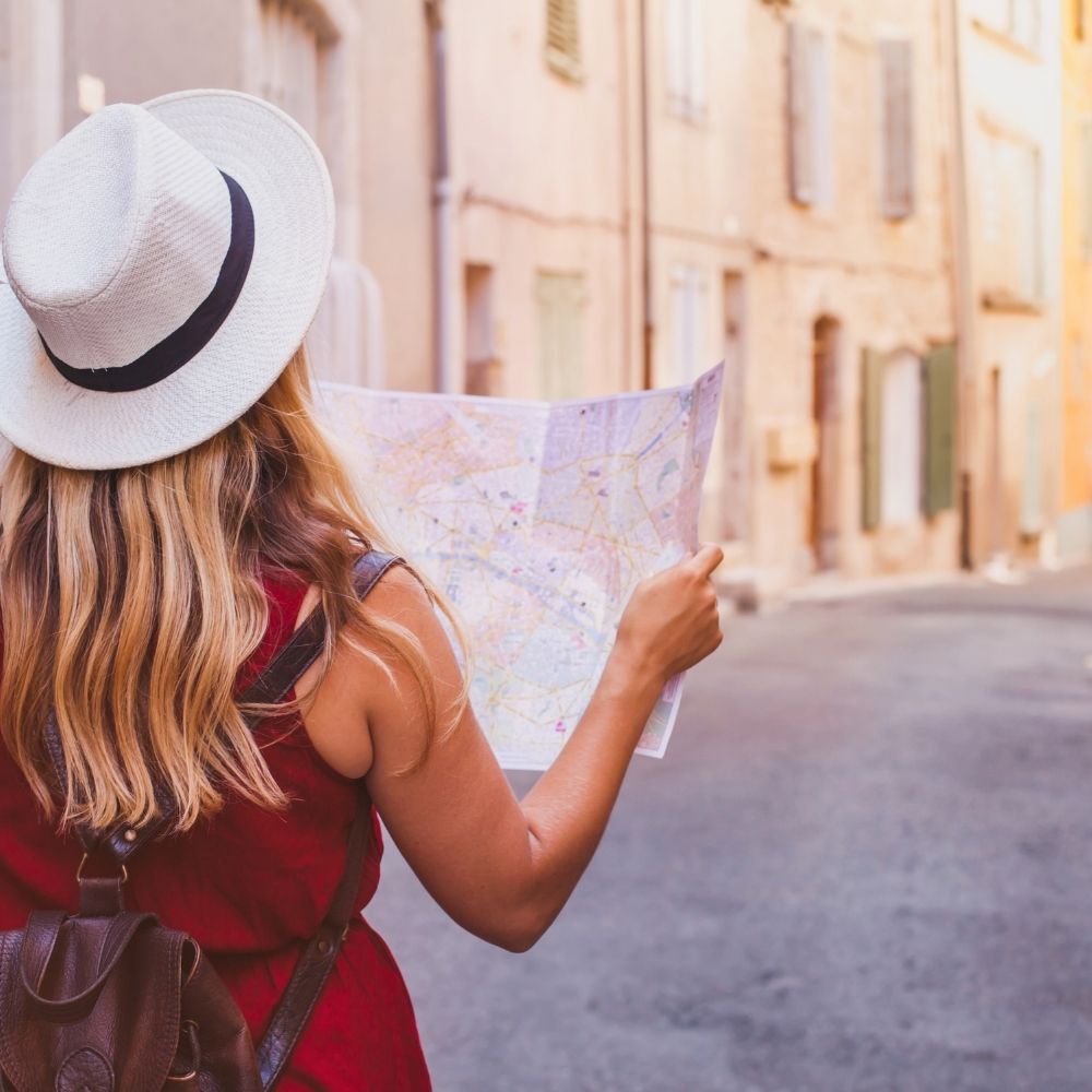 woman looking at a map while travelling