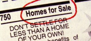newspaper with homes for sale circled in red