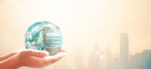 person holding a globe with a mask around it