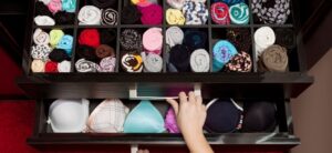 person reaching into their underwear drawer