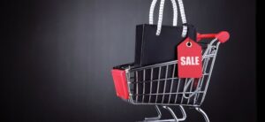shopping trolley with bags and sale sign