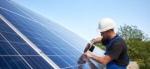 solar panels being attached to a rooftop