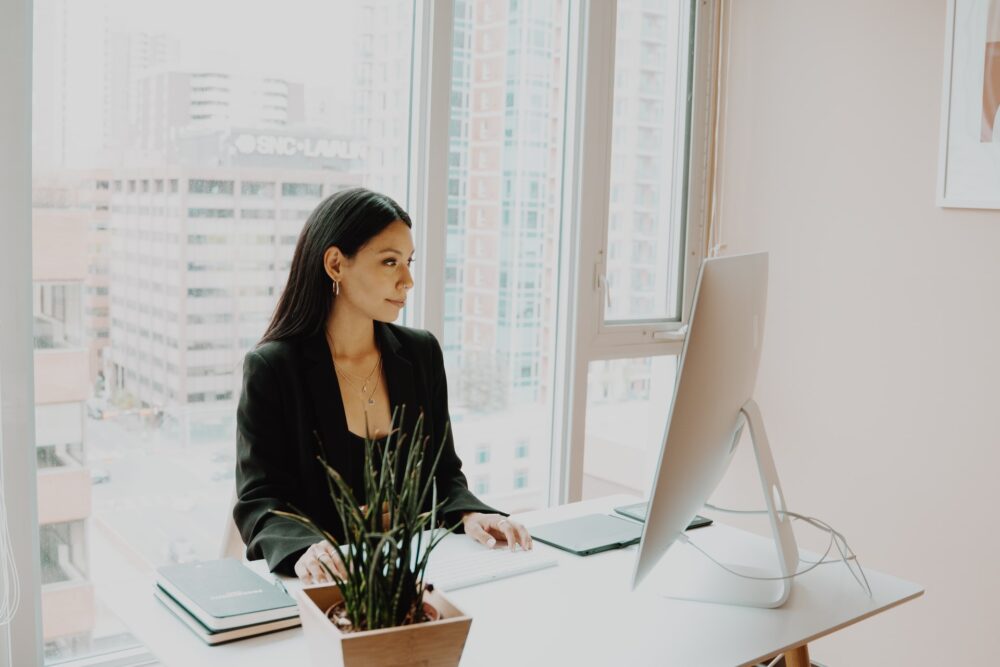 women wearing black sitting in front of a computer