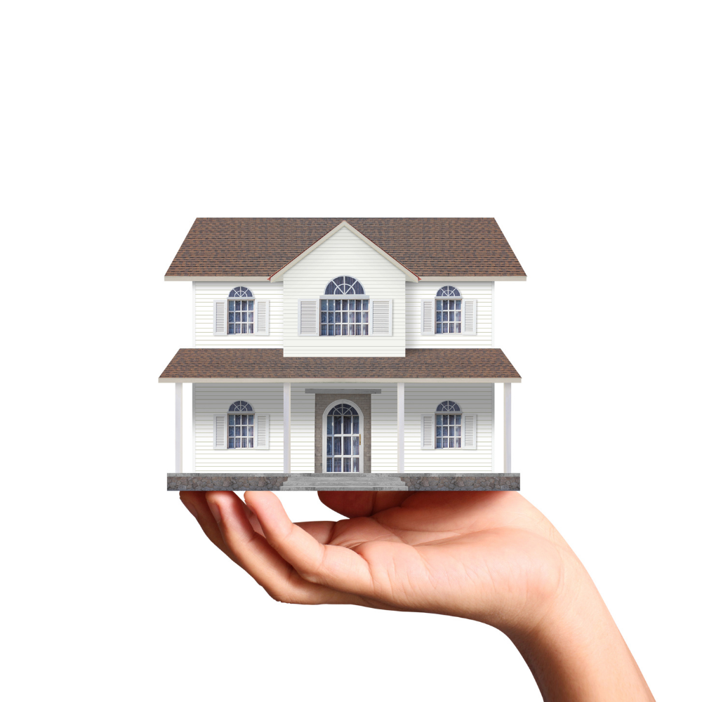 person holding a model house in their hand