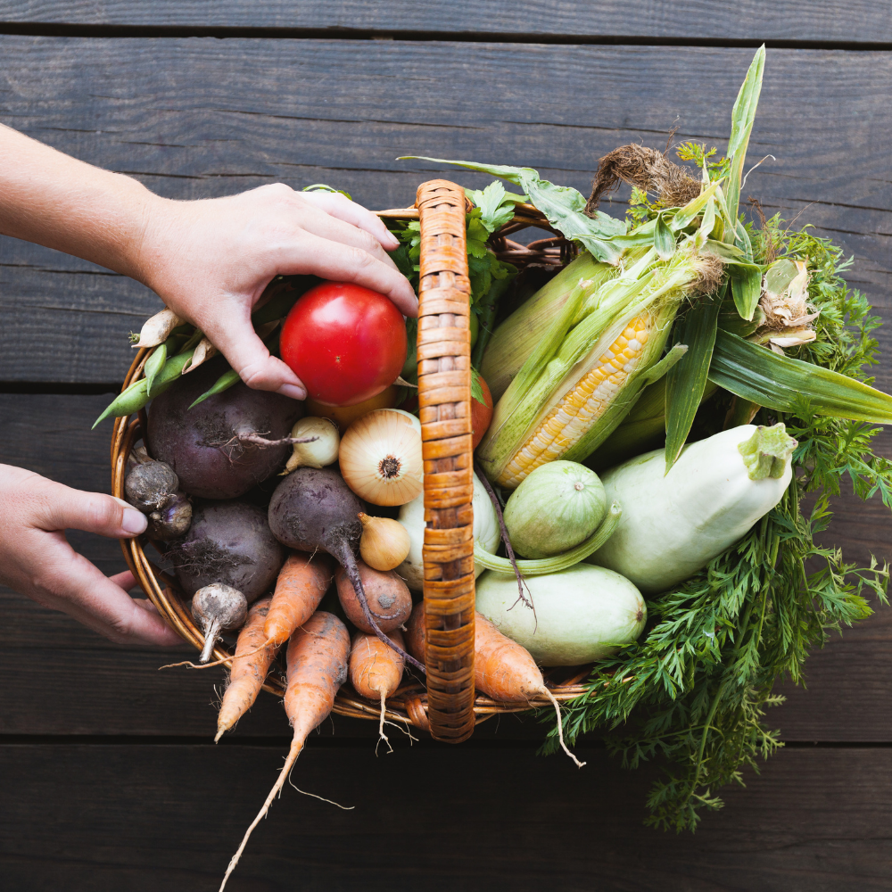 person with a basket of fruit and vegetables