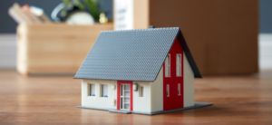 small model house with moving parcels behind it