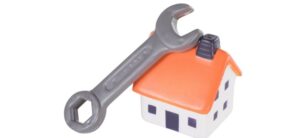 spanner resting on top of a model house