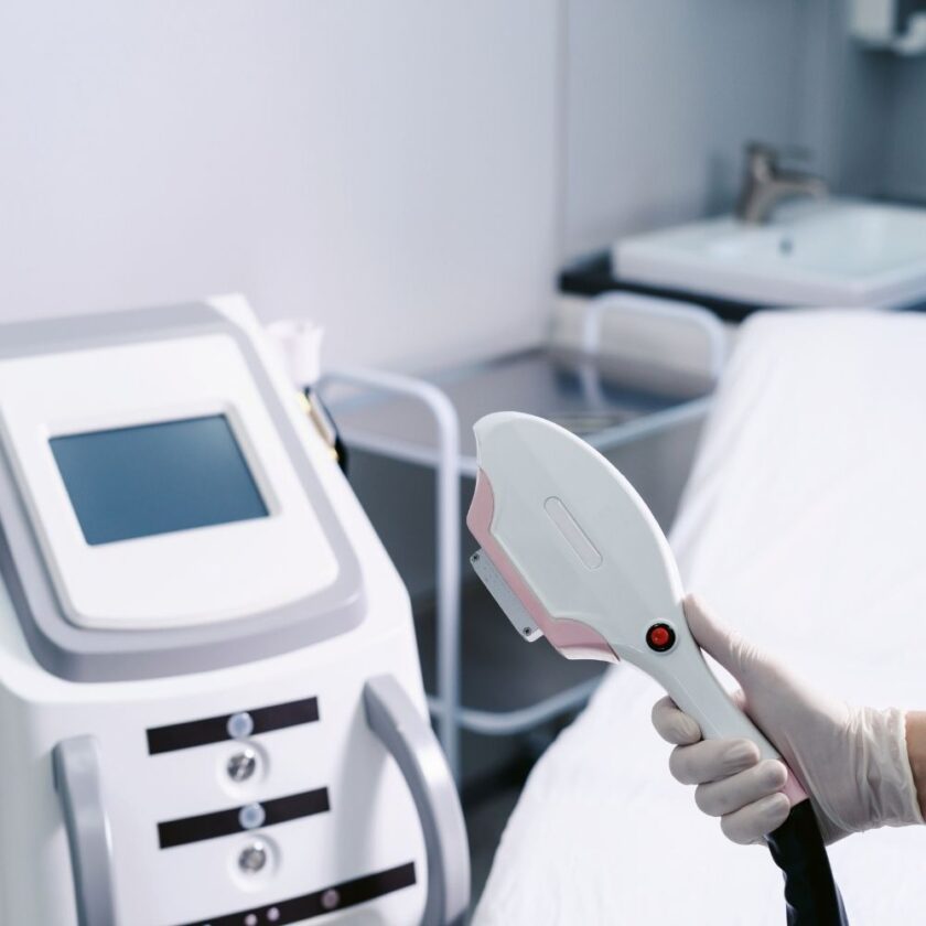 laser hair removal device held by a technician