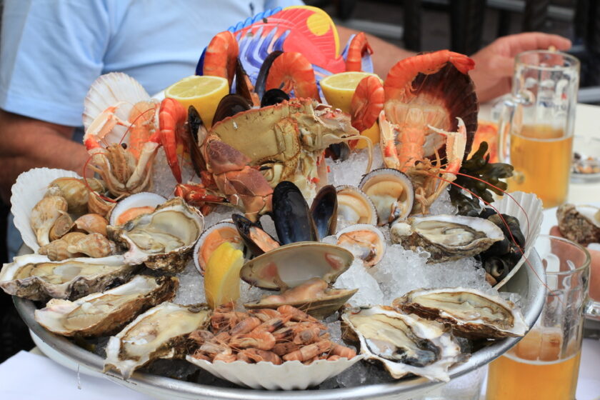 Seafood buffet with fresh oysters, clams, crabs, shrimps, snails, lobsters and beer in restaurant