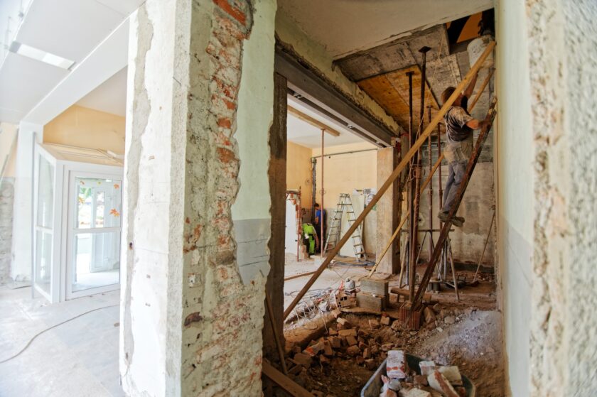 Person working hard renovating a building