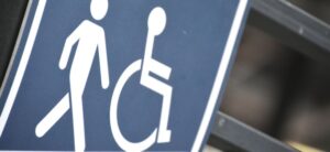 sign showing a person walking and a person in a wheelchair