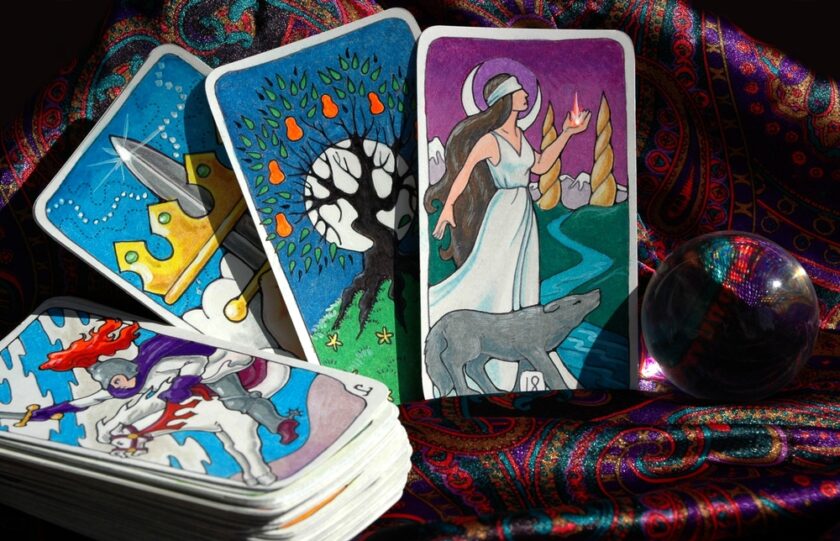 Tarot cards in a pile with a few on show next to it