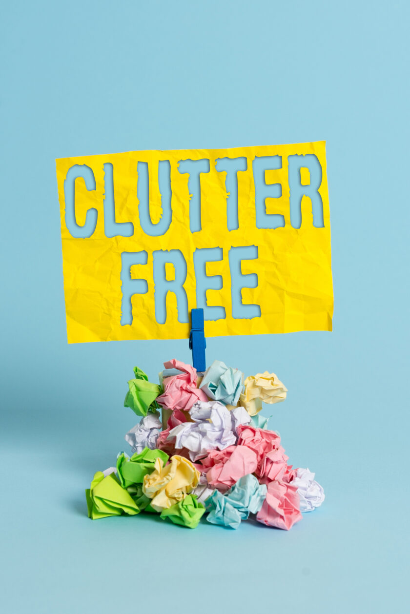Handwriting text Clutter Free. Conceptual photo Well organized and arranged Tidy All things in right places Reminder pile colored crumpled paper clothespin reminder blue background