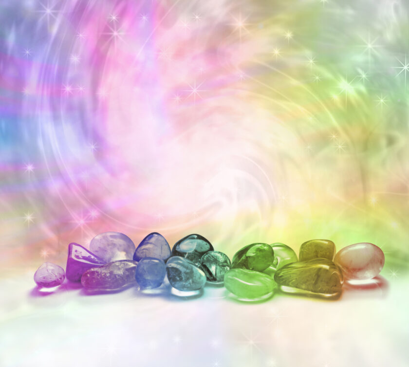 Coloured glass crystals against a rainbow backdrop 