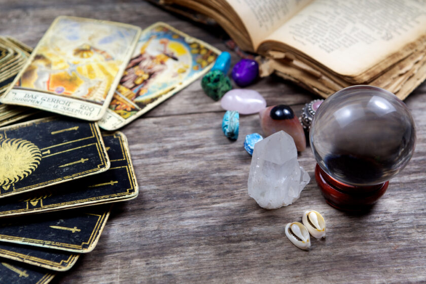 tarot cards and crystals on a wooden backdrop